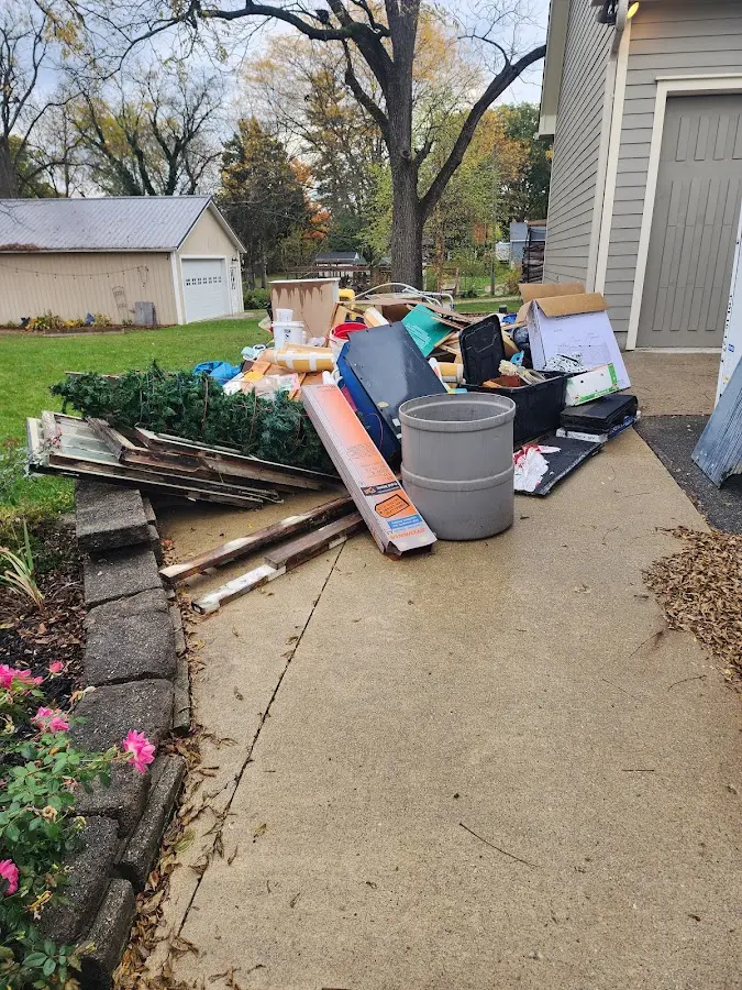 Dumpster being loaded with debris for 12 Yard Dumpster Rental in North Salt Lake